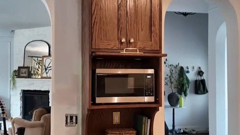 Microwave garage against a wall in a kitchen