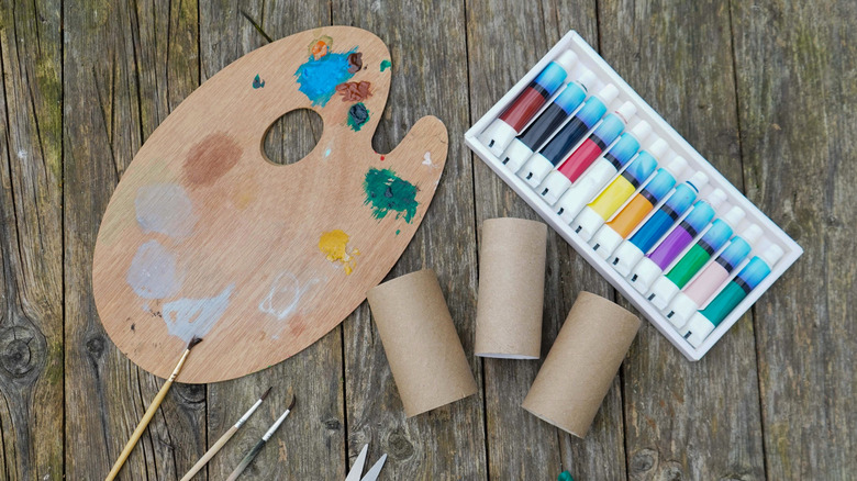 Toilet paper rolls and other craft supplies on a wooden table