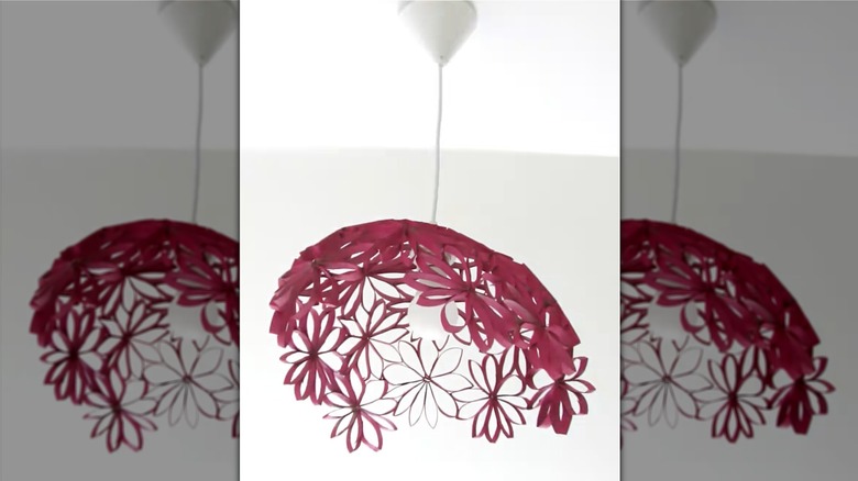 A pendant light with a DIY lampshade made from old toilet paper rolls.