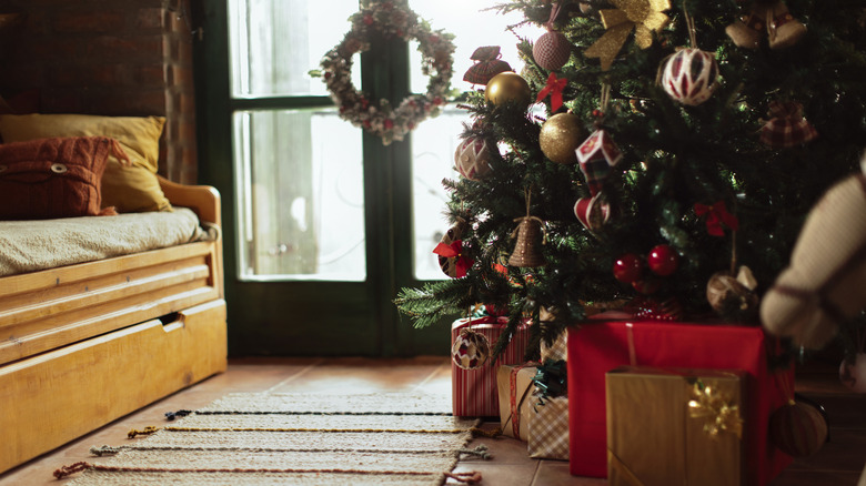 Christmas tree with presents underneath and festive wreath