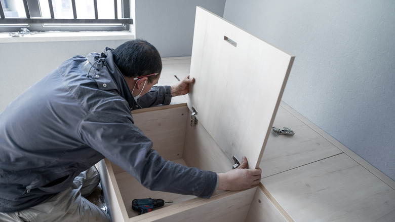 man assembling kitchen cabinets