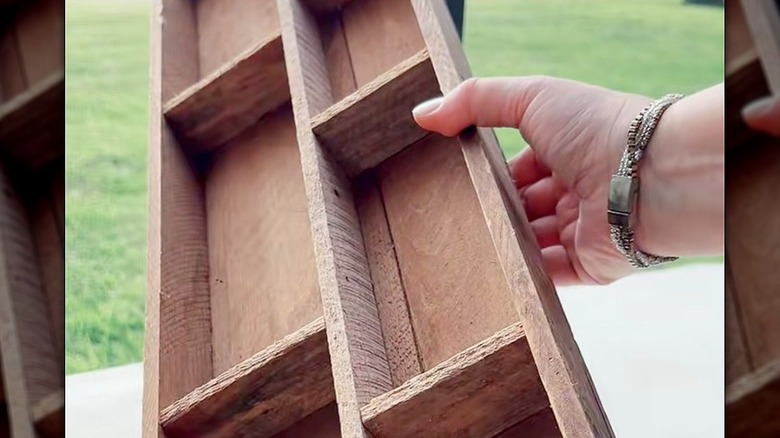 Hand holding segmented wooden organizer