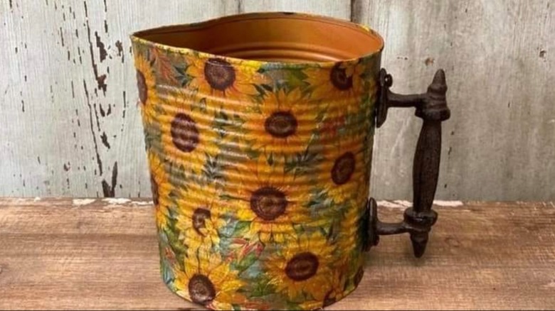 DIY watering can made out of old metal canister and old drawer handle.