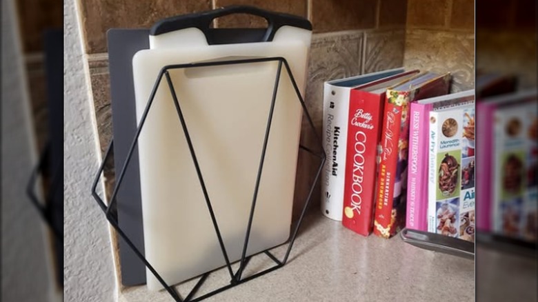 Metal magazine rack holding cutting boards