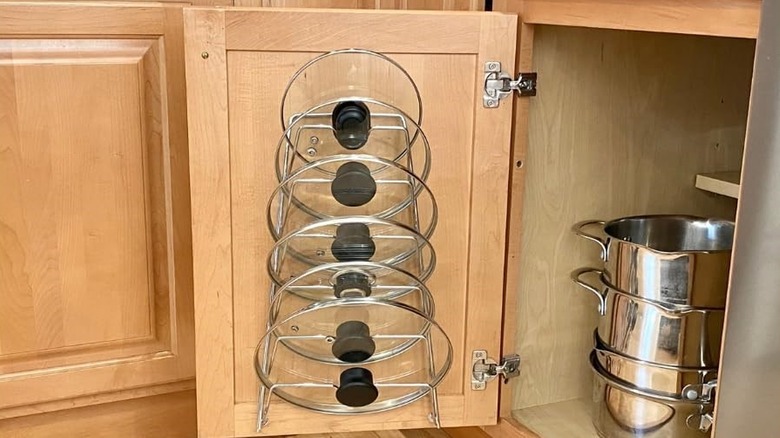 Metal rack used for organizing lids in cabinet