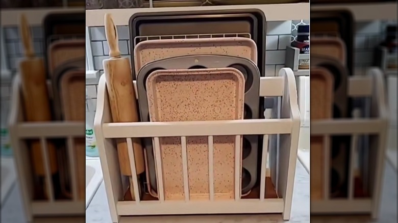 Sheet pans and tins in wooden magazine rack
