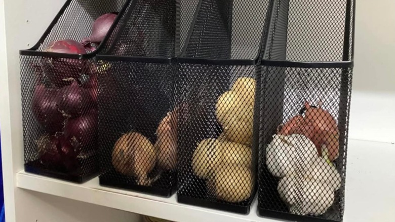 Onions, potatoes and garlic in mesh magazine holders