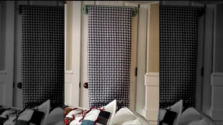 A quilt displayed on a vintage towel rack