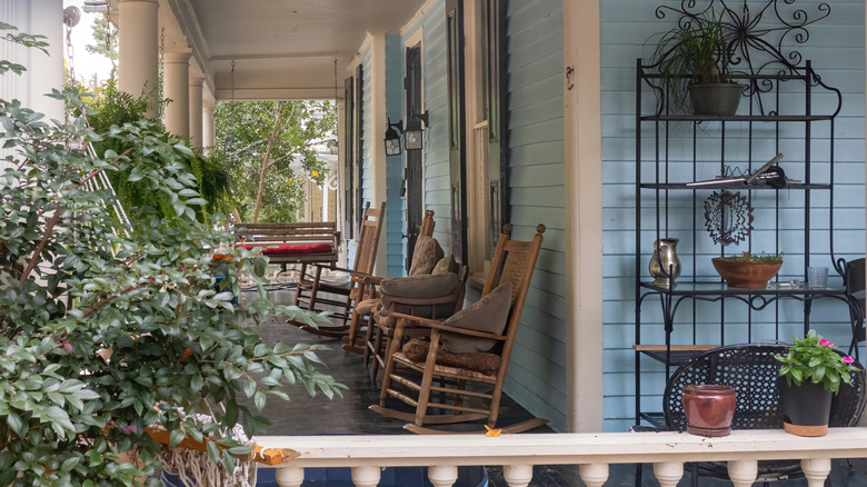A porch with chairs and other furniture