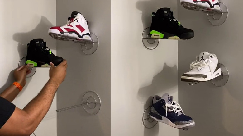 Sneakers displayed on a wall-mounted paper towel holder