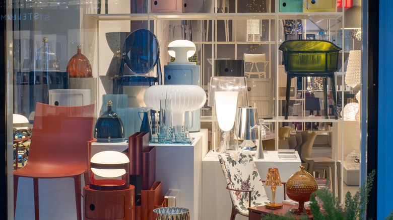 store front window featuring funky lamps and other elegant interior pieces