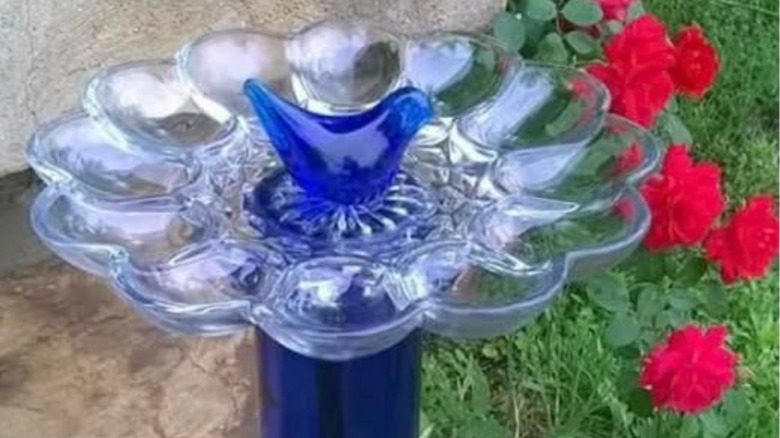 Egg platter bird bath in garden