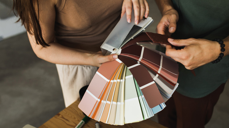 Homeowners using color swatches to decide on cabinet color
