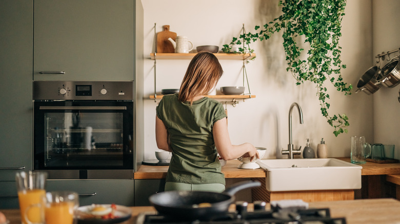 A woman standing in a decorated kitchen