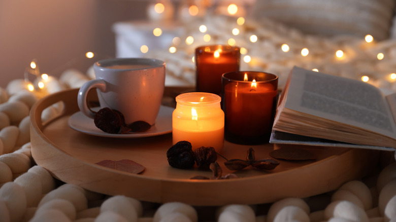 A fall-themed candle display on a table