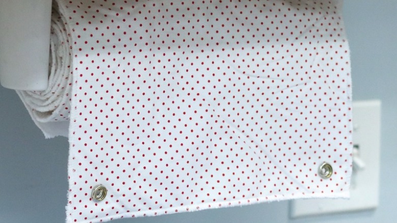 The roll of reusable towels hanging on a paper towel holder.