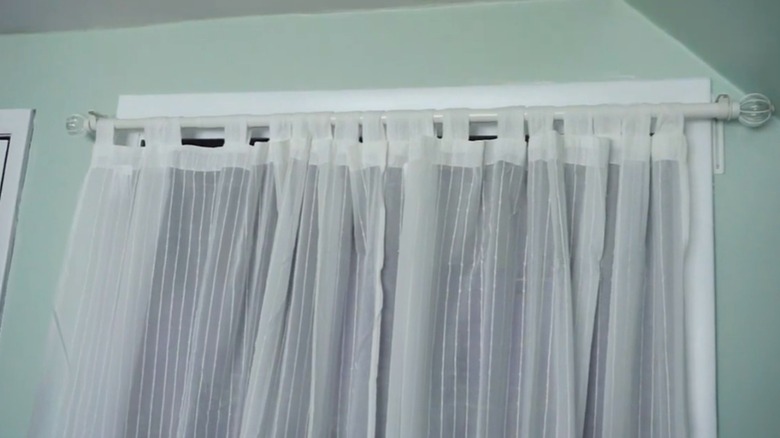 Closed curtain in front of open closet