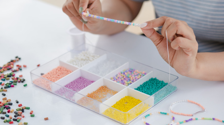 Person stringing beads