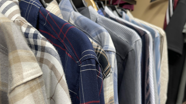 close up of a closet full of button-down shirts
