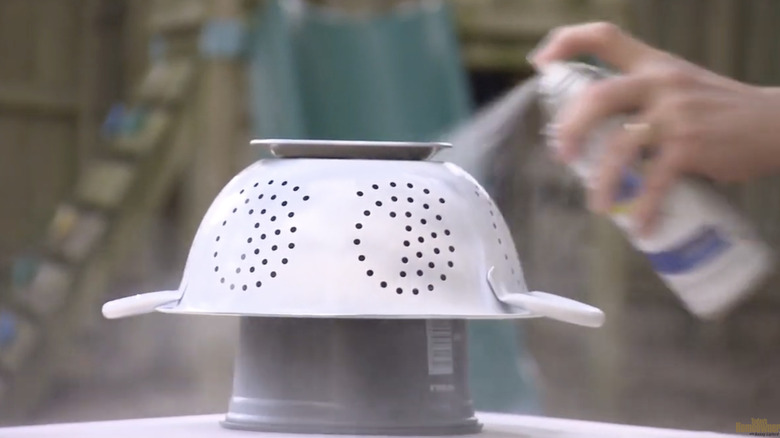 Old metal colander painted blue and turned into a succulent planter.