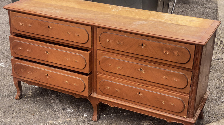 old dresser sitting on street