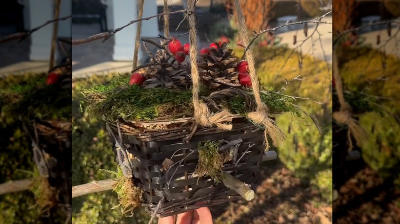 A bird feeder made out of an old easter basket with a woodland theme