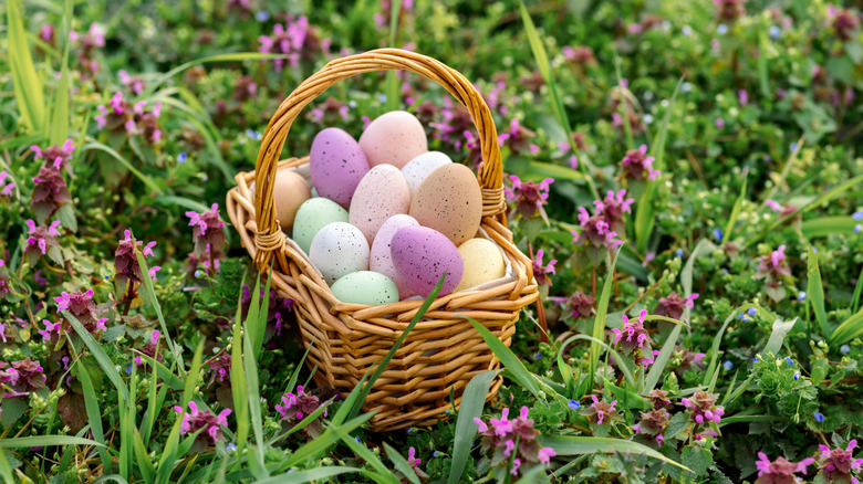 Colorful eggs in a brown wicker easter basket