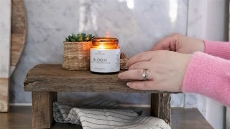 A riser made from a wooden fence board