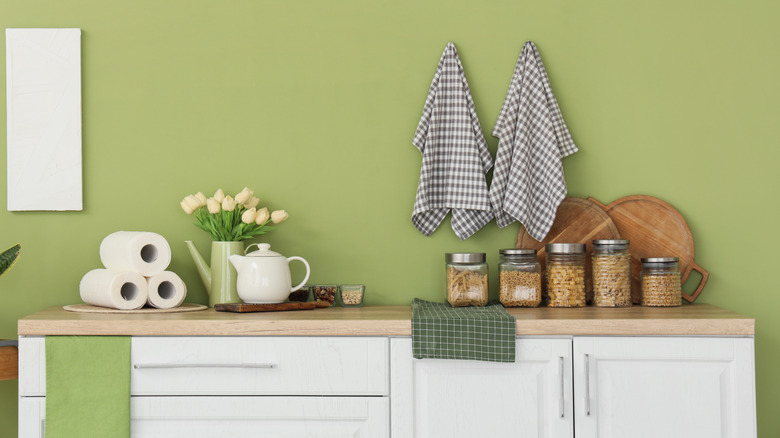 A kitchen countertop filled with jars and other items
