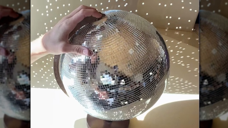 A classroom globe covered in reflective tiles.
