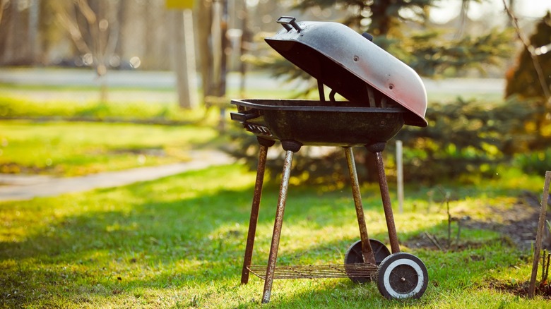 A rusty grill sitting outdoors