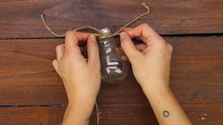 Person DIYing a lightbulb vase