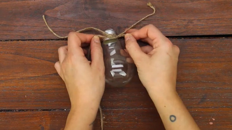 Person DIYing a lightbulb vase