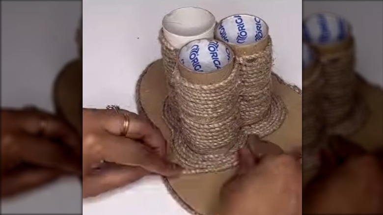 Person gluing twine to DIY pen holder