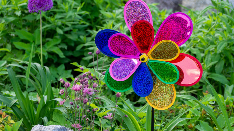 A colorful sequined wind spinner in a garden