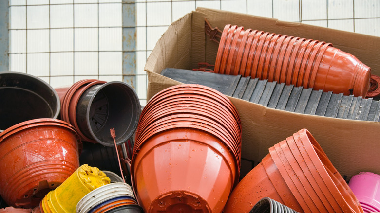 Plastic planters sitting in a pile to be used or recycled.