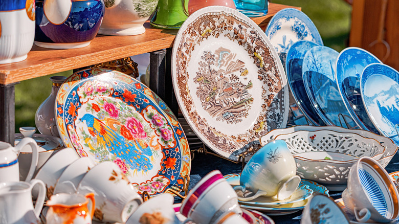 Vintage porcelain cups and plates on wooden stand