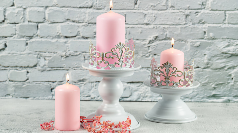 Pink candles in candle stands