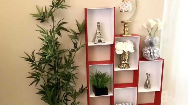 A shelving unit made from old shoe boxes in a living room.
