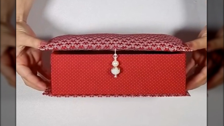 Shoe box made into a jewelry box with red fabric