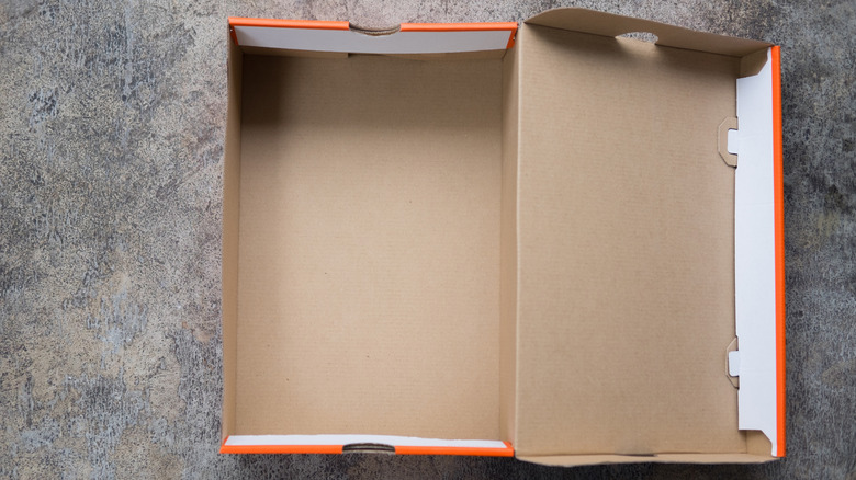 Open shoe box laying on a counter