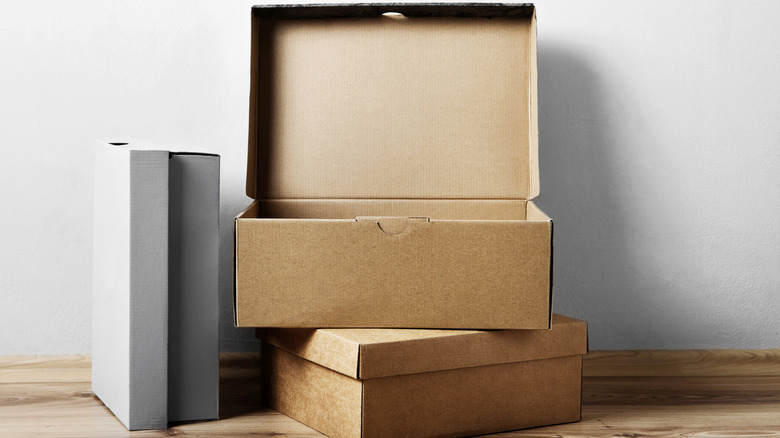 Brown and gray shoe boxes on the floor