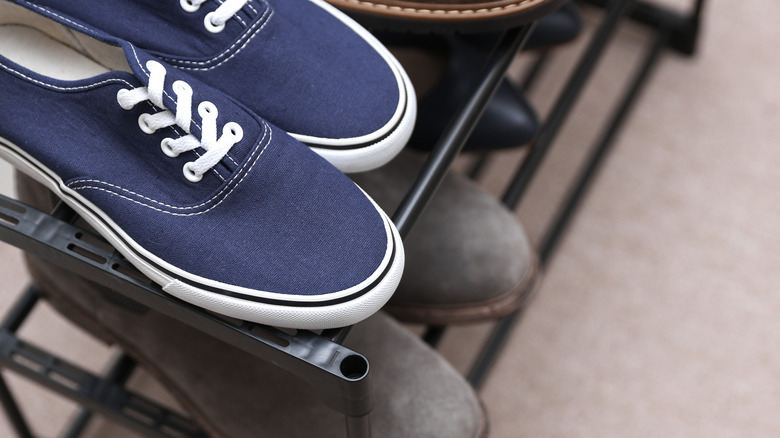 Metal shoe rack with bar shelves.