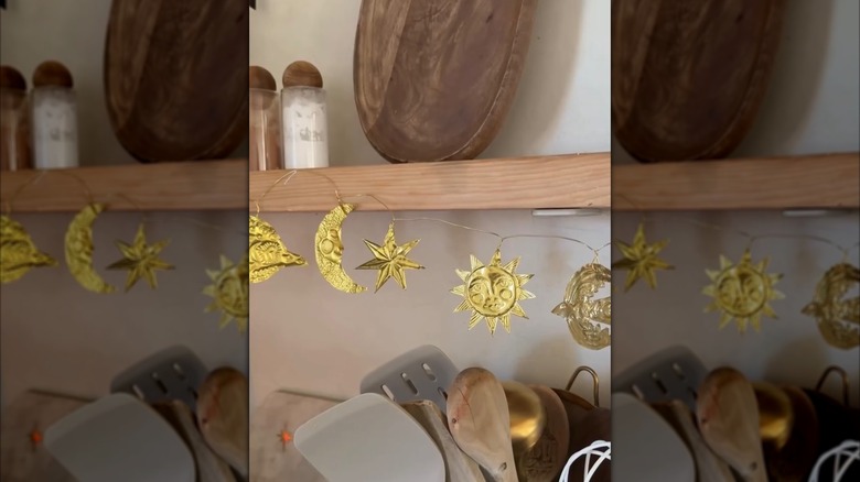 Garland of gold embossed metal stars, suns, and moons