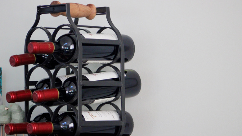 A metal wine rack resting on a countertop.