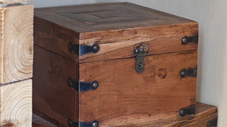 close up of antique wood box on top of another wood box