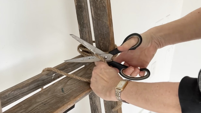 Woman sanding old wooden stepladder