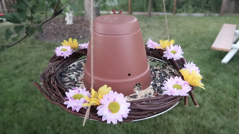 A DIY bird feeder made from a splatter screen.