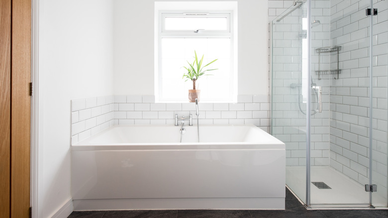 A basic bathtub in a white-themed bathroom