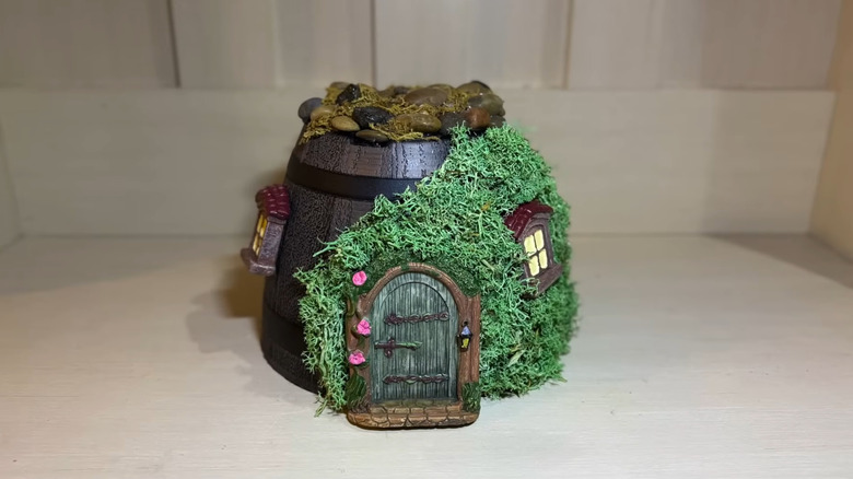 a fairy garden made with items from dollar tree's fairy garden collection